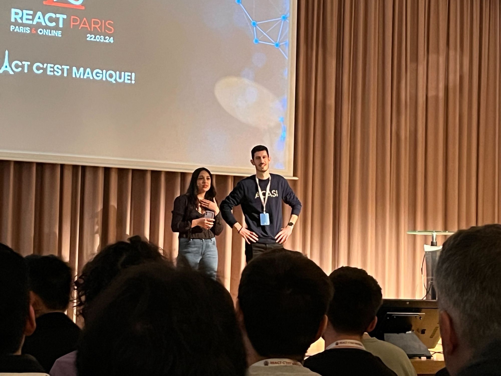 Opening ceremony of React Paris, we see Marcy on the left part of stage and Mathew on the right