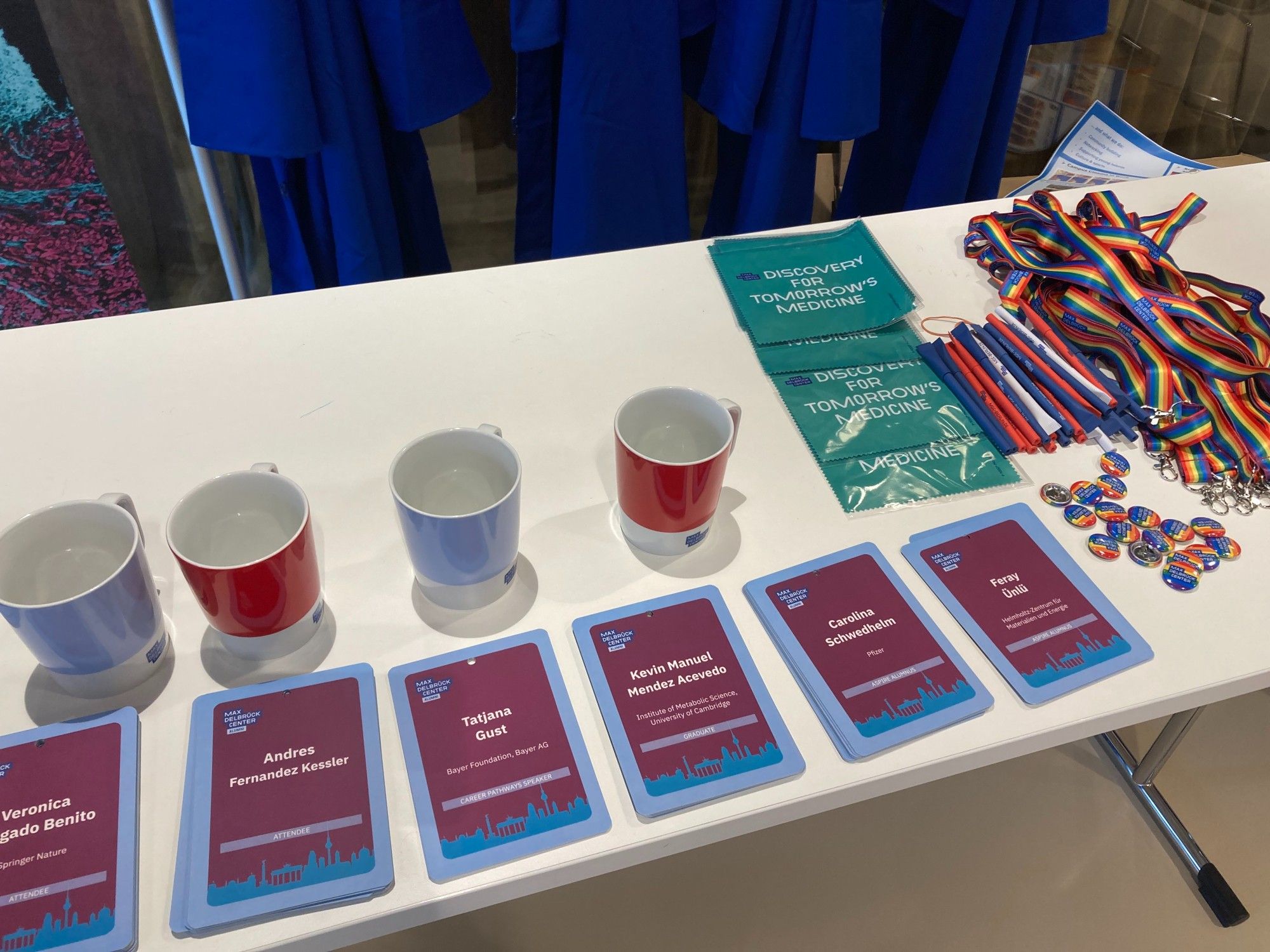 Close-up photo of giveaways and name tags at the check-in desk for the MDC alumni meeting and PhD graduation.