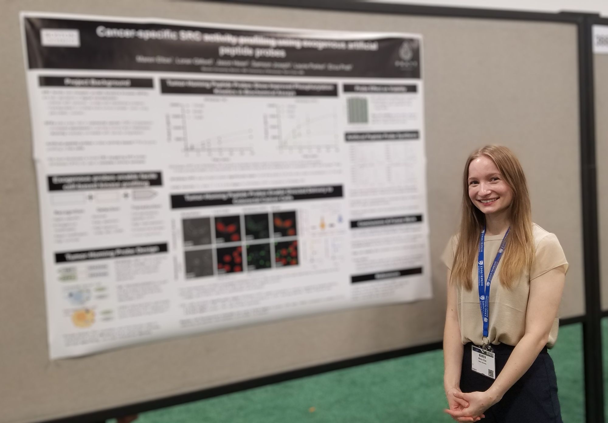 Maren smiling in front of a poster board.