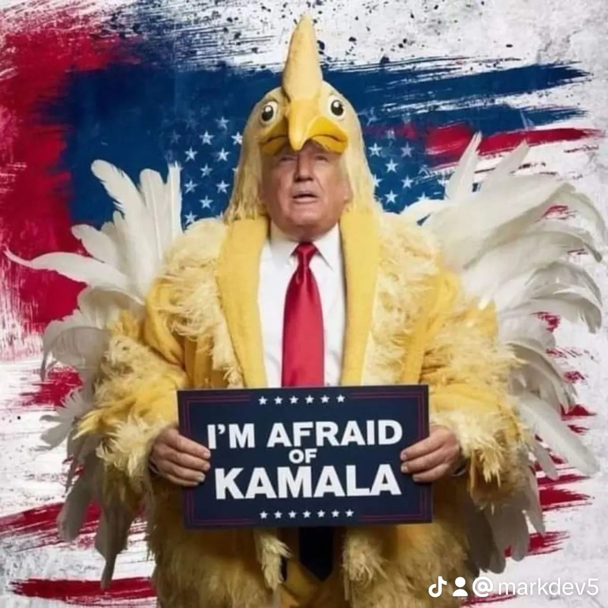 Trump in a chicken suite, holding a sign saying I'm afraid of Kamala