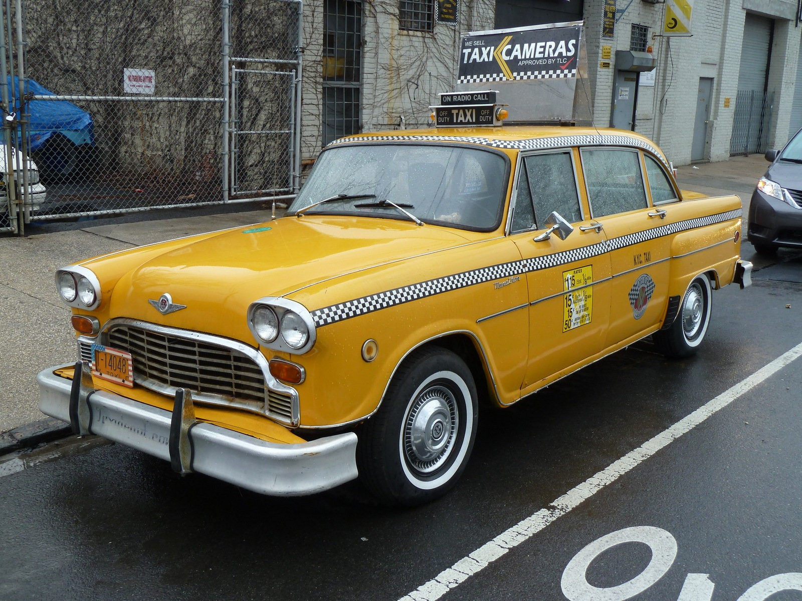 A NYC "checker cab", probably not the original style but echoing it (I didn't take the time to look for a better image)

Source:
https://www.nytimes.com/2014/06/20/automobiles/checker-cabs-return-to-gotham.html