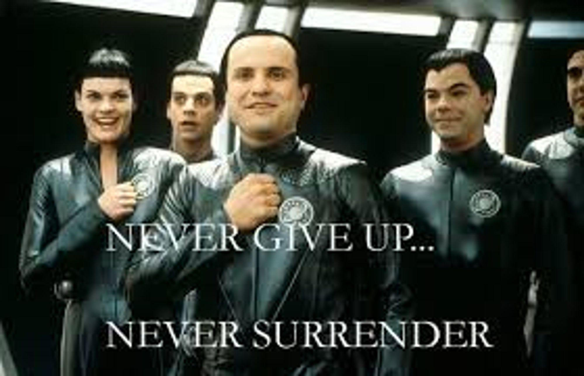 A still from Galaxy Quest, the aliens that have reconstructed the spacecraft from broadcasts of a version of Star Trak are arrayed under the text, a catchphrase from the show, "Never give up ... never surrender"