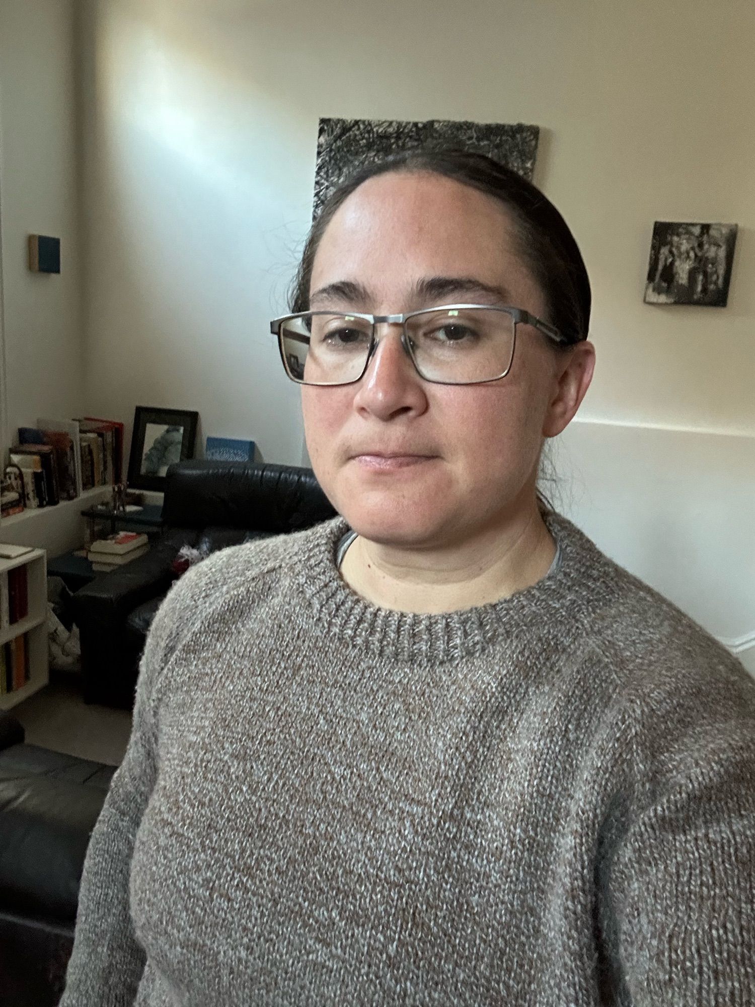 selfie of Rachel in a handknit brown/gray sweater that has been mostly depilled. not pictured: the cut from where her thumb got in the way