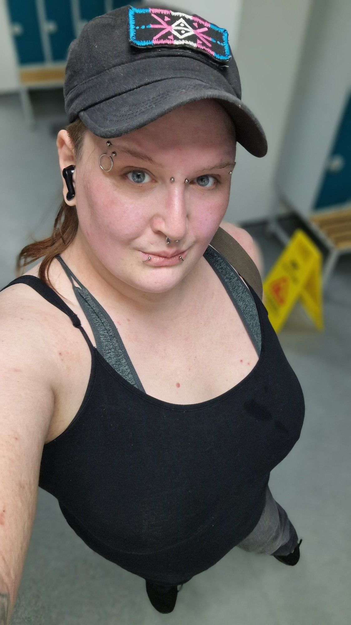 Krissy again in a similar top, sportsbra straps visible, and the cap.