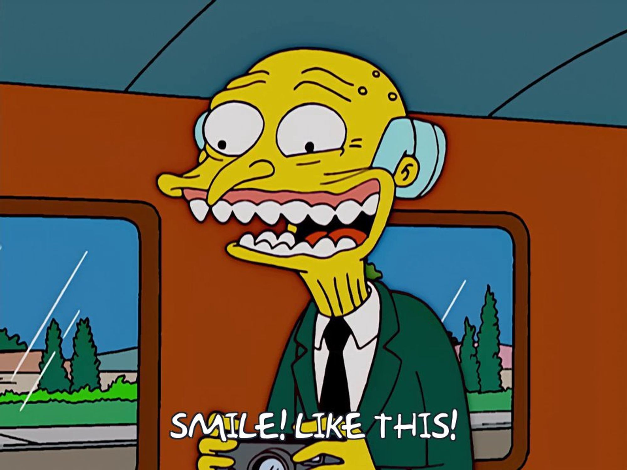 Monty Burns attempting some sort of ghoulish, toothy "smile." Text reads: "Smile! Like this!"