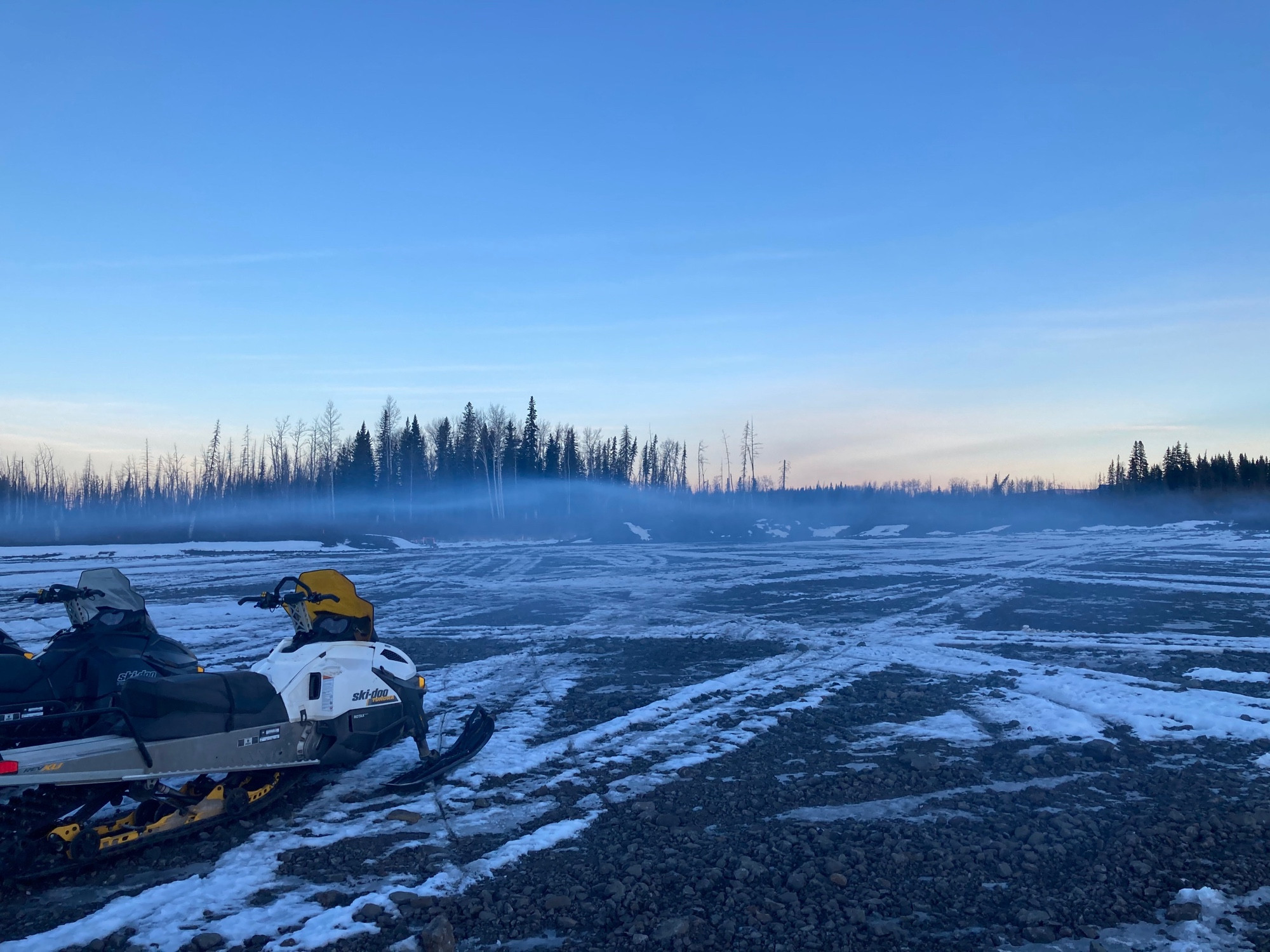 A picture of the smog from several snowmobiles forming a distinct layer just above the ground.
This picture was taken in a 0.064-square-kilometre cleared area at 9:41 am.