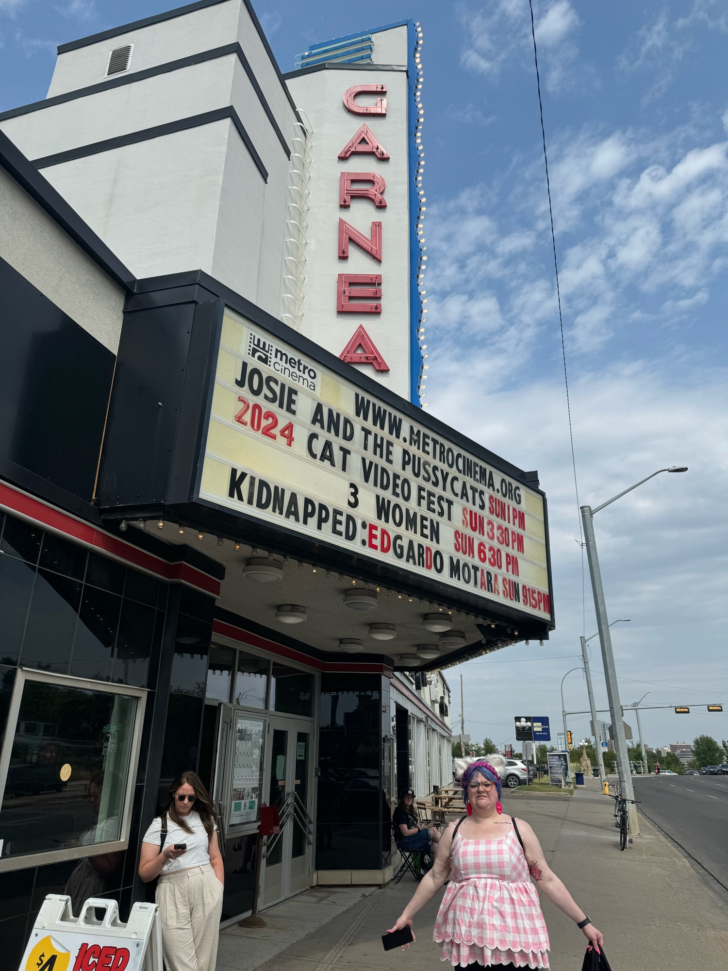 Chelsea looking silly in front of a theatre