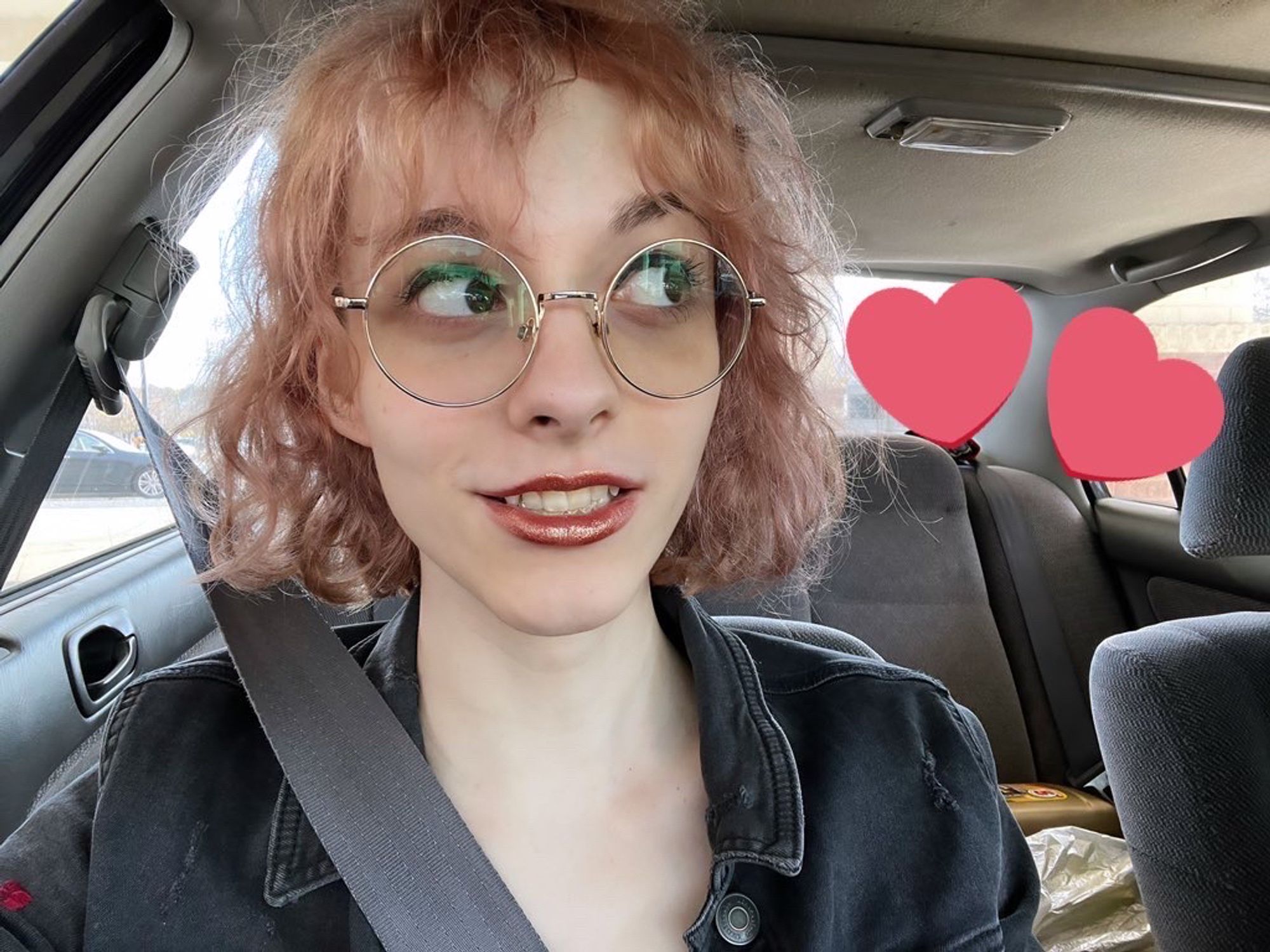 selfie of me smiling in a car with glittery rose gold lipstick on