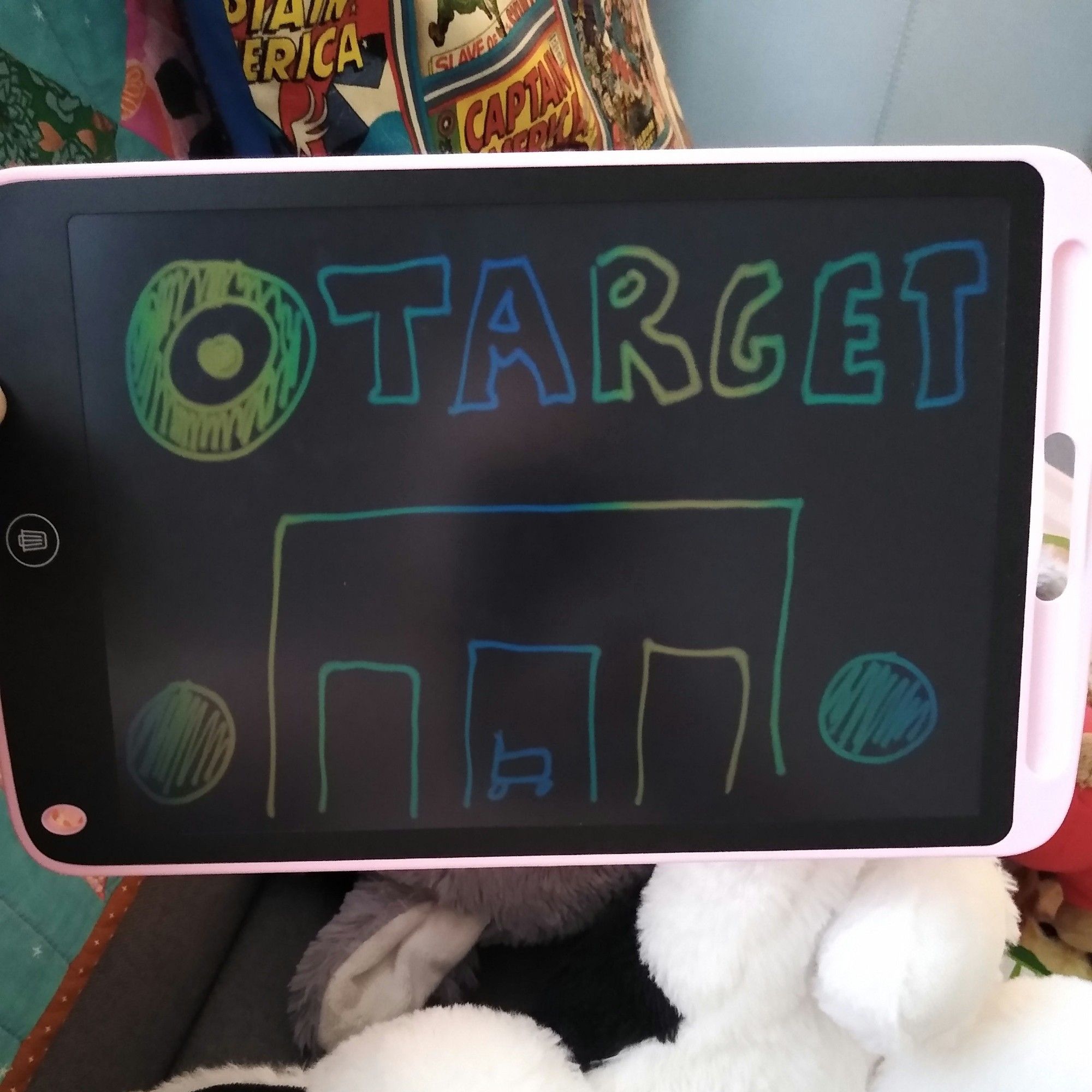 A reusable writing tablet with a crude drawing of the front facade of Target, complete with orbs and sign