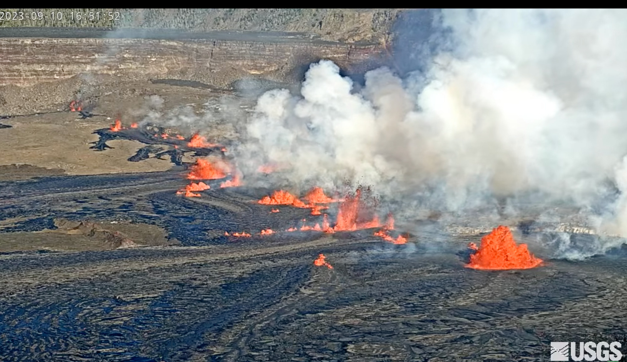 Screenshot of live feed of Kīlauea Volcano, Hawaii (Halemaʻumaʻu crater) showing multiple lava showers and lots of smoke