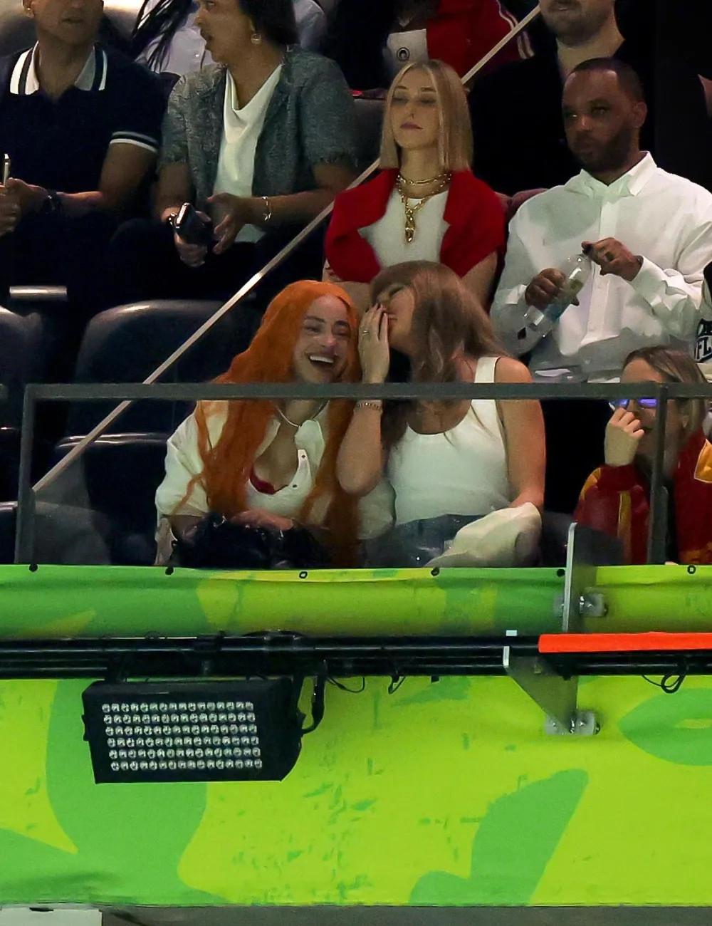 Taylor Swift whispering in Ice Spice’s ear at the Superbowl where she was booed for existing.