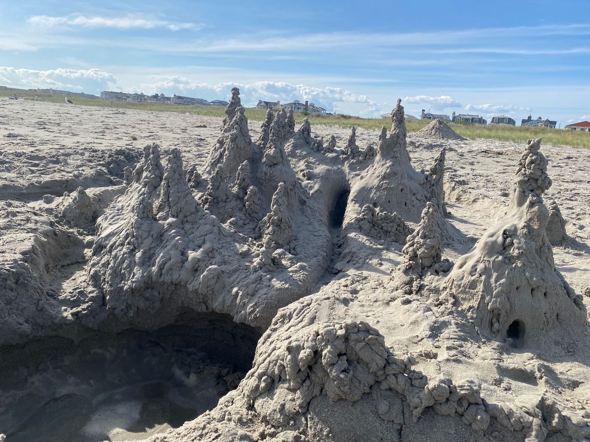 sand castle with spires of dripped sand