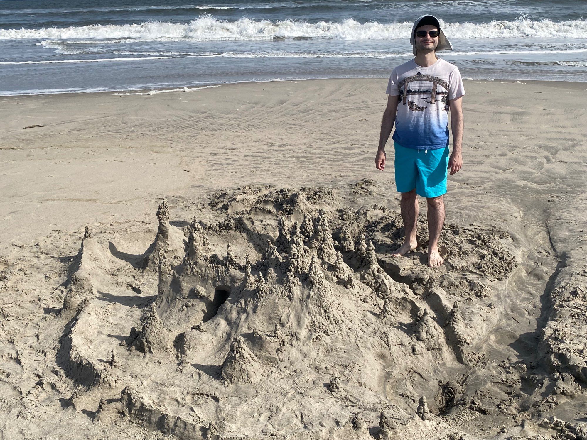 Mason posing with sand castle