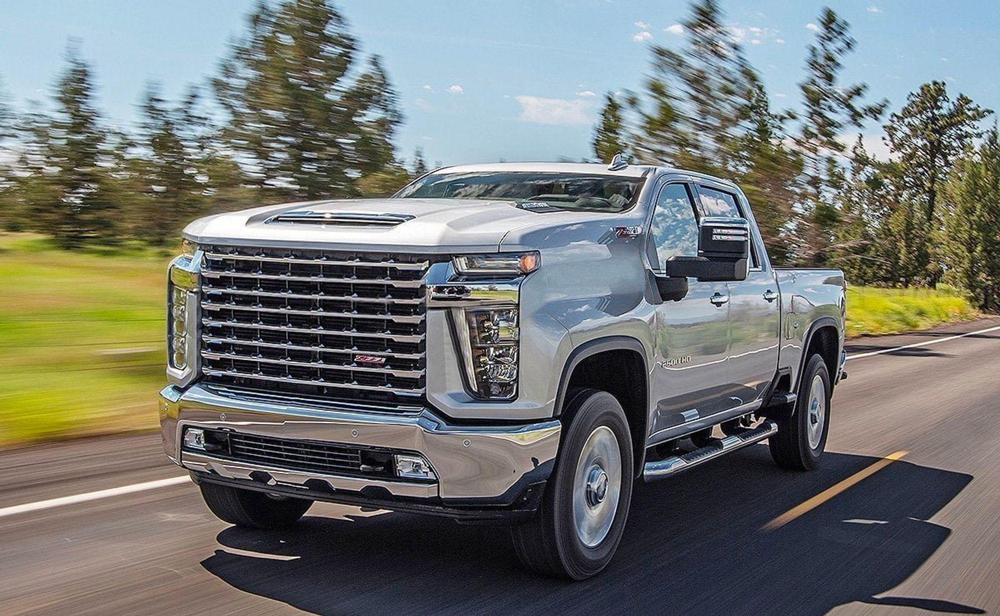 Photoshopped image of a pickup truck with a front-end that is so large that it obscures almost the entire windshield. It is totally absurd yet believable because it really isn't all that far the design of today's actual automobile industry products.