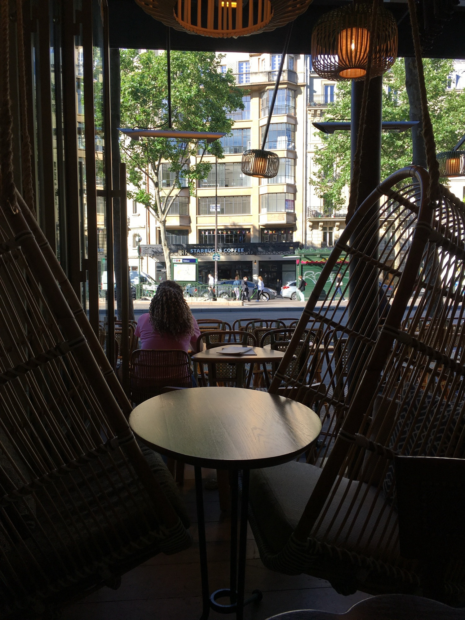 Grands fauteuils en rotin dans un café à Paris, Odéon.