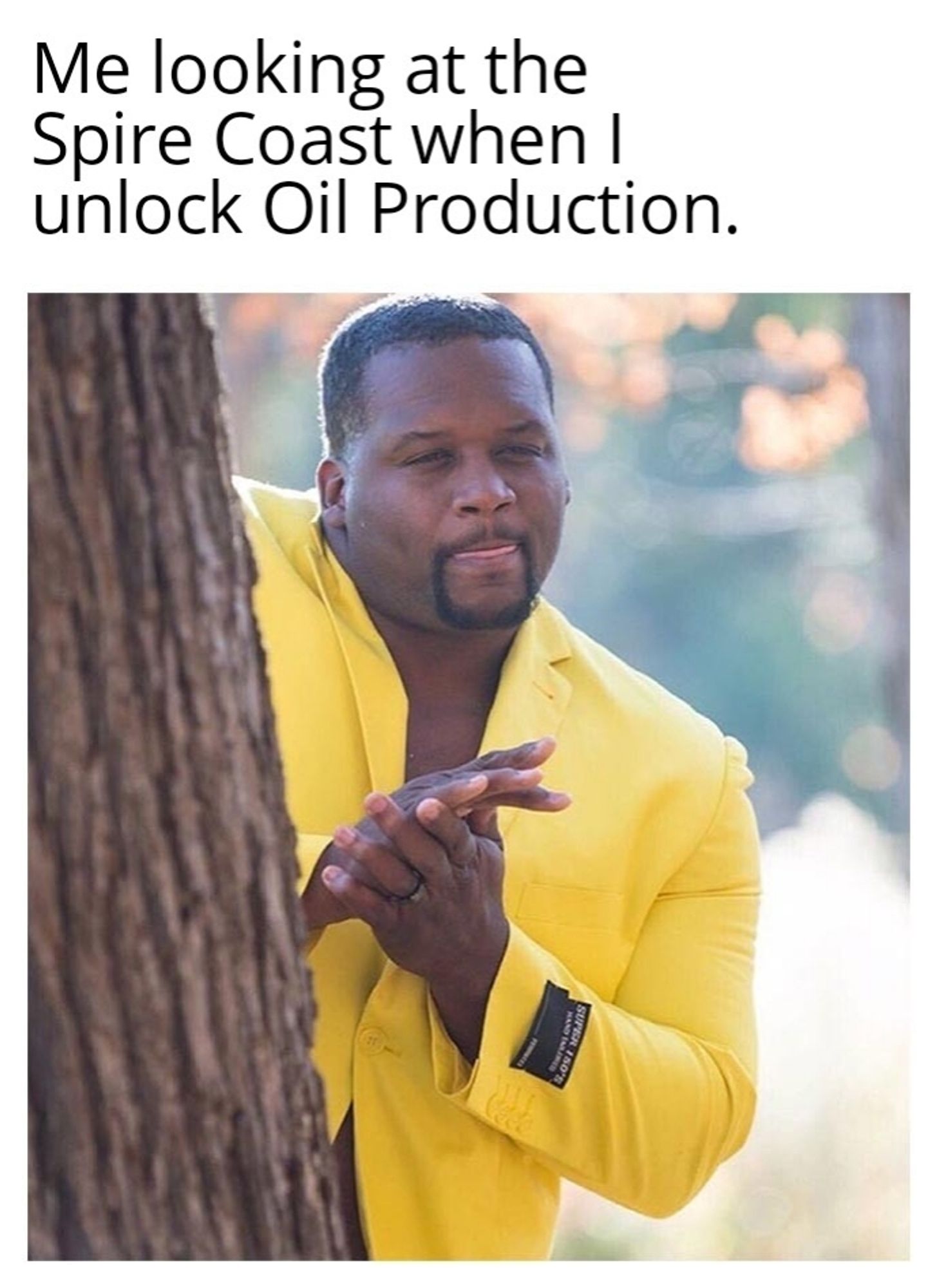 Spice Adams Meme where his he is looking at something while hiding behind a tree, rubbing his hads together and licking his lips. The caption reads "Me looking at the Spire Coast when I unlock Oil Production."