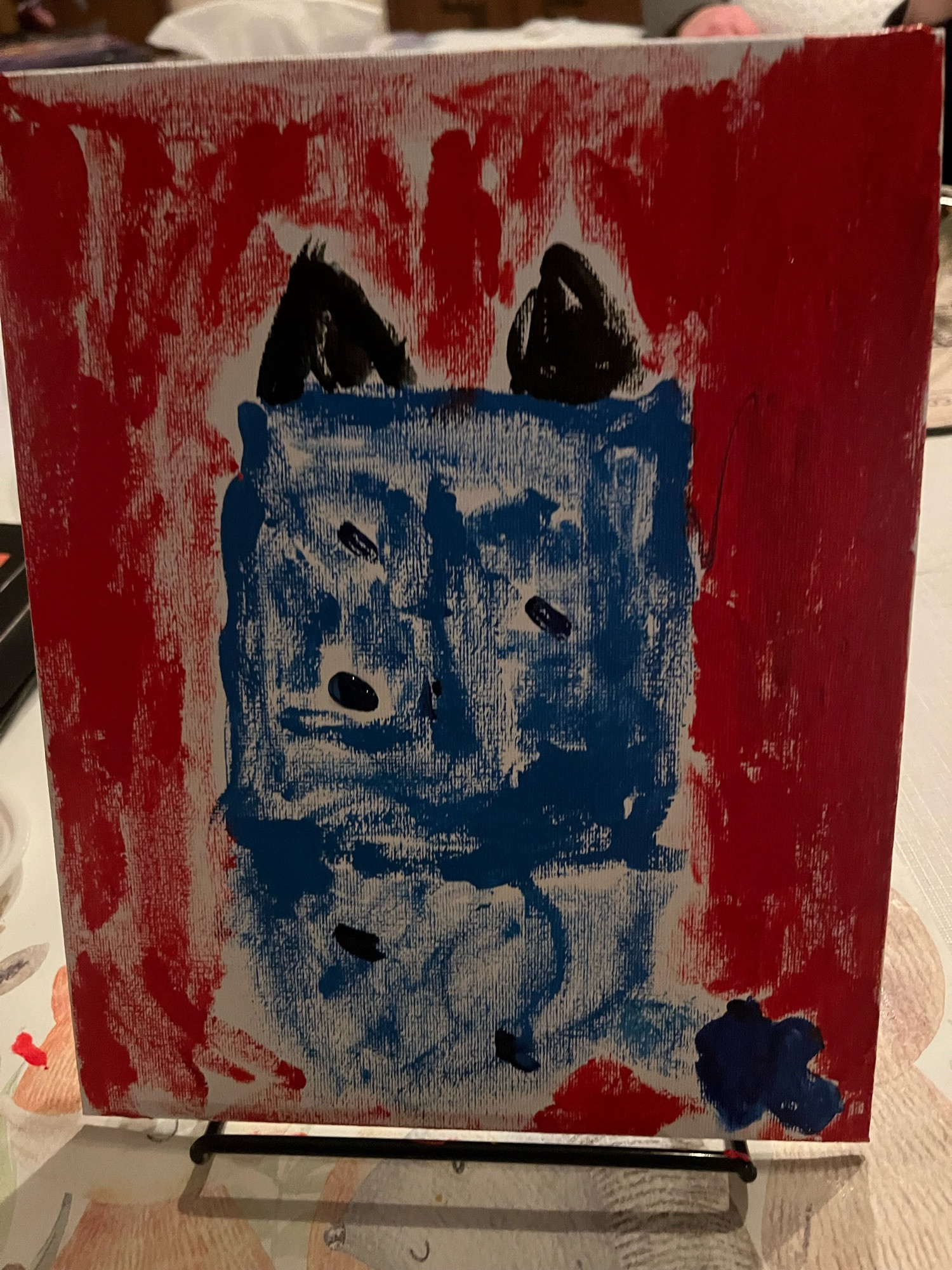 A perfect painting my perfect daughter did of Bluey’s back with excellent proportions and a perfect tail against a red background.