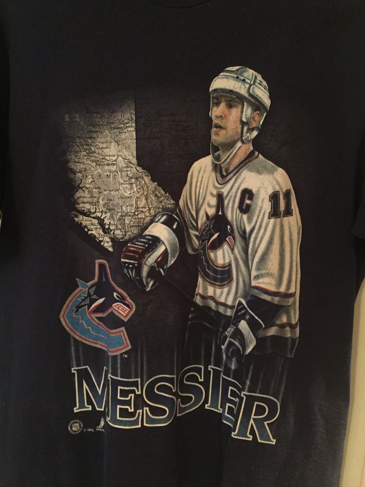 My favourite shirt. It has a map of BC and Mark Messier (a handsome enough white man), dressed in his Canucks hockey gear