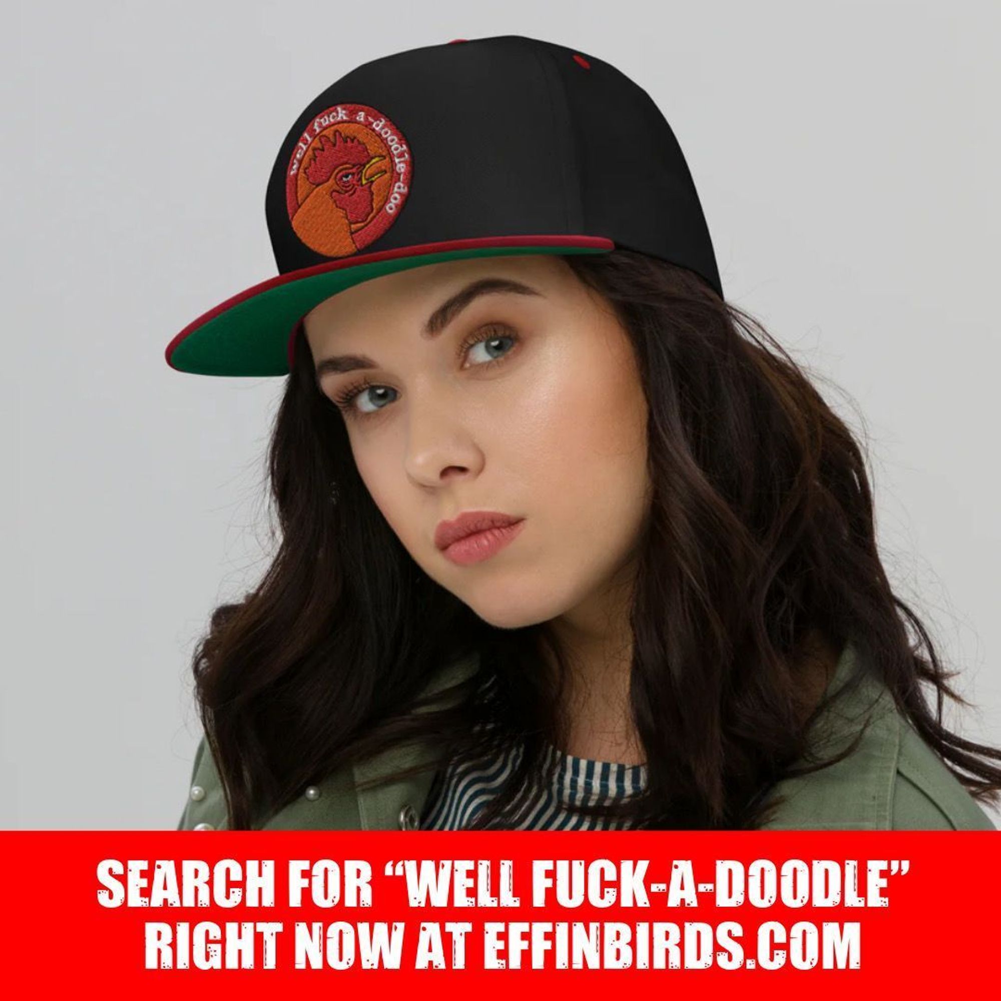 A photo of a woman wearing flat bill style baseball cap featuring a logo of a rooster surrounded by the words “well fuck-a-doodle doo”