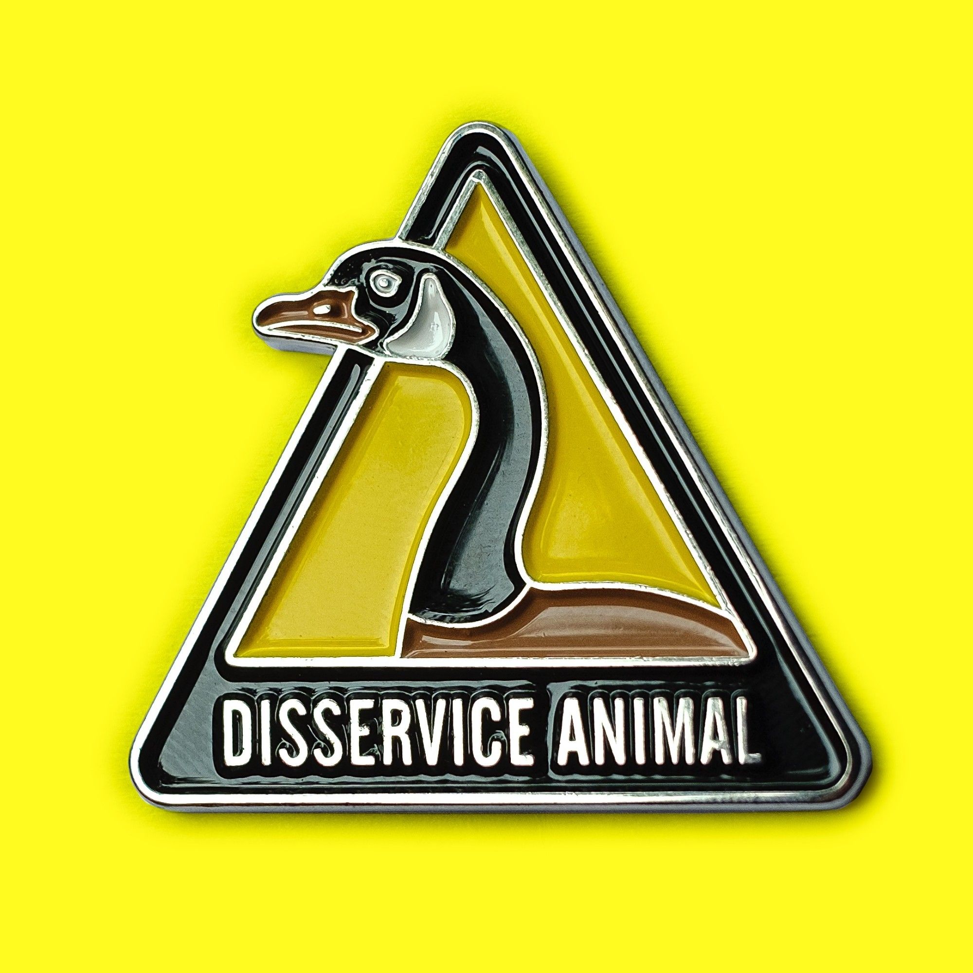 An enamel pin that says Disservice Animal