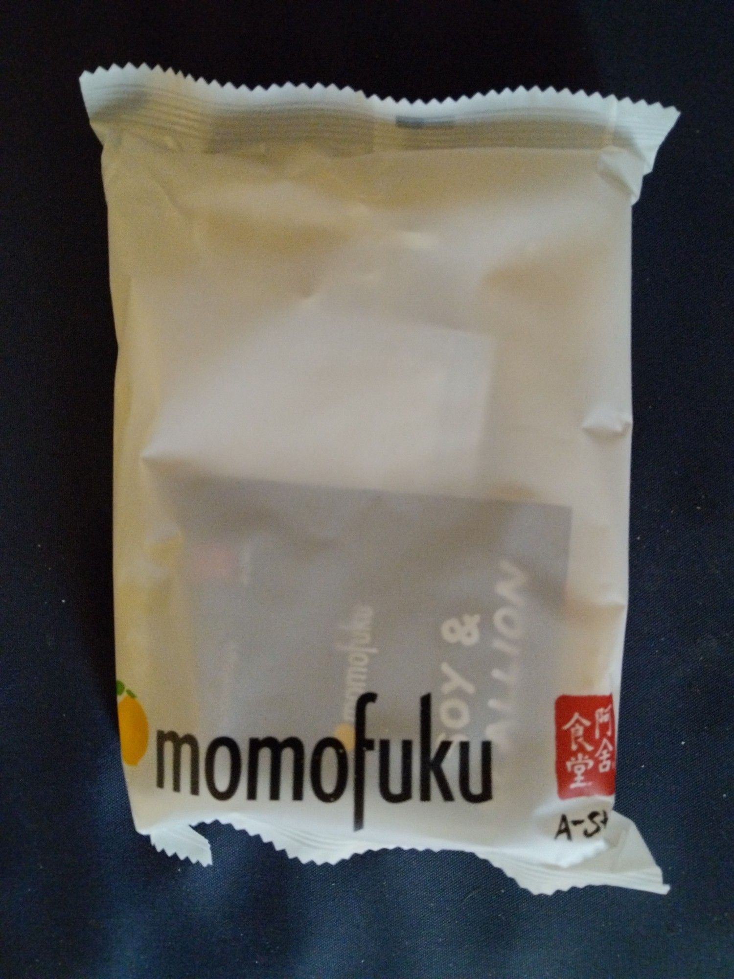 An off white package of dried noodles with the word momofuku at the bottom