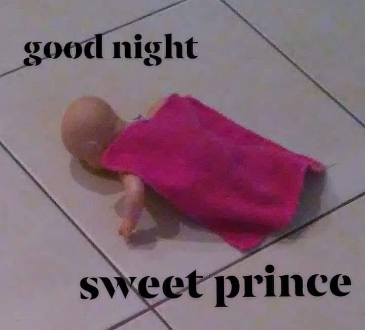 Baby doll laying face down on white tile floor with a small pink blanket covering its body. Text reads: "good night sweet prince"