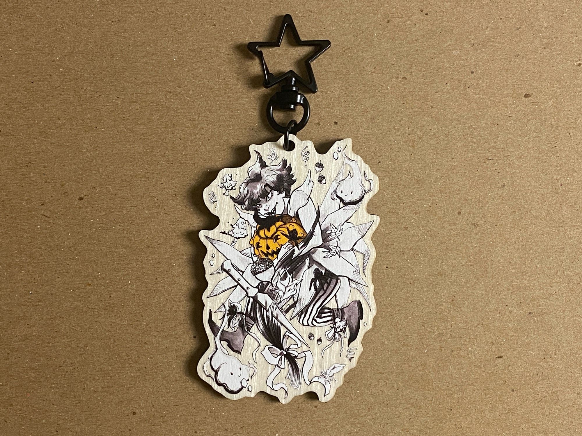 Vintage style Halloween illustration on a synthetic wooden keychain. Art is a black and white image of a human holding an orange jack o lantern pumpkin.