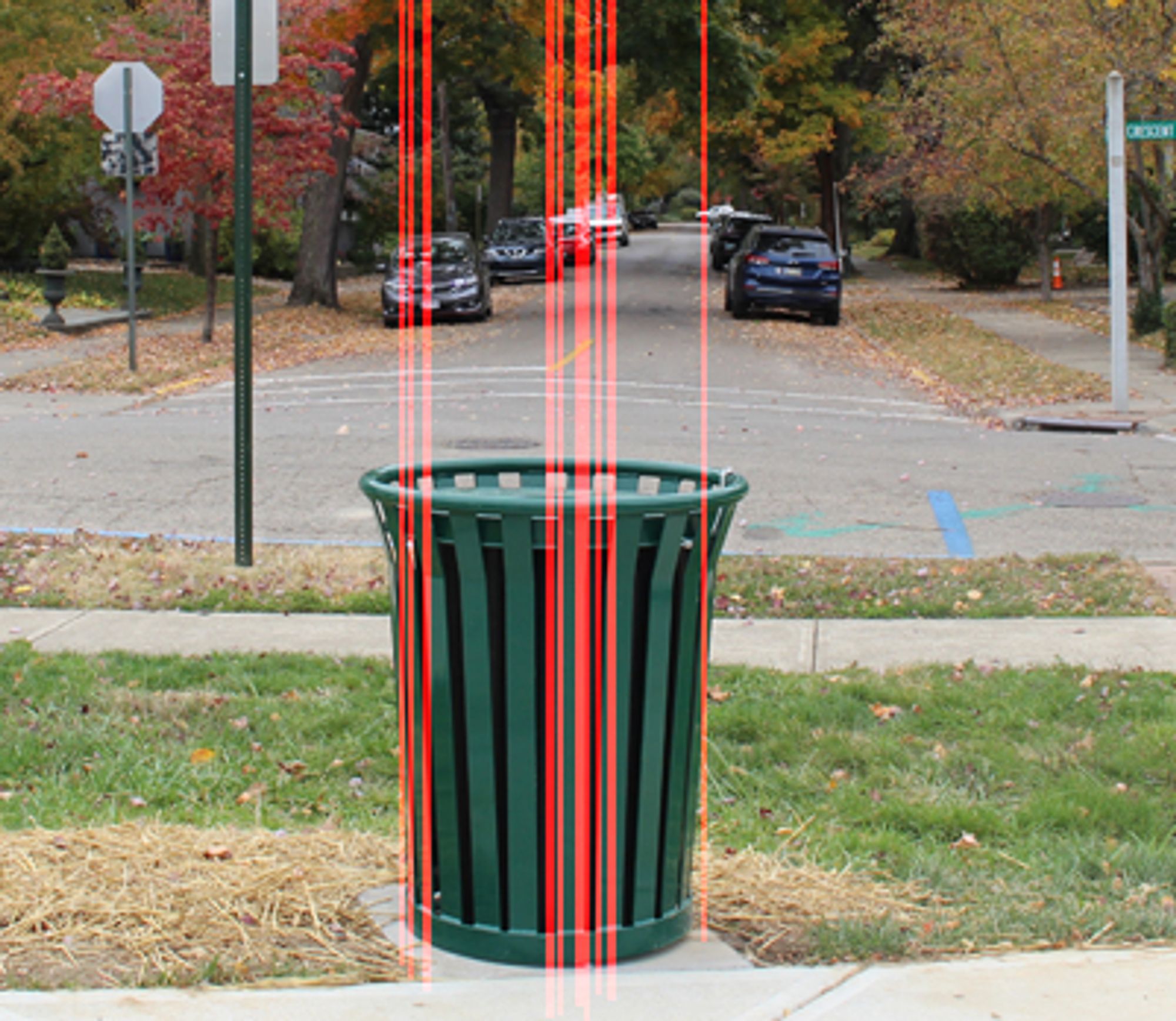 An image of an outdoors trashcan. Red lines and rectangles have been drawn on it to indicate invisible walls caused by misaligned floors allowing ceiling to leak through