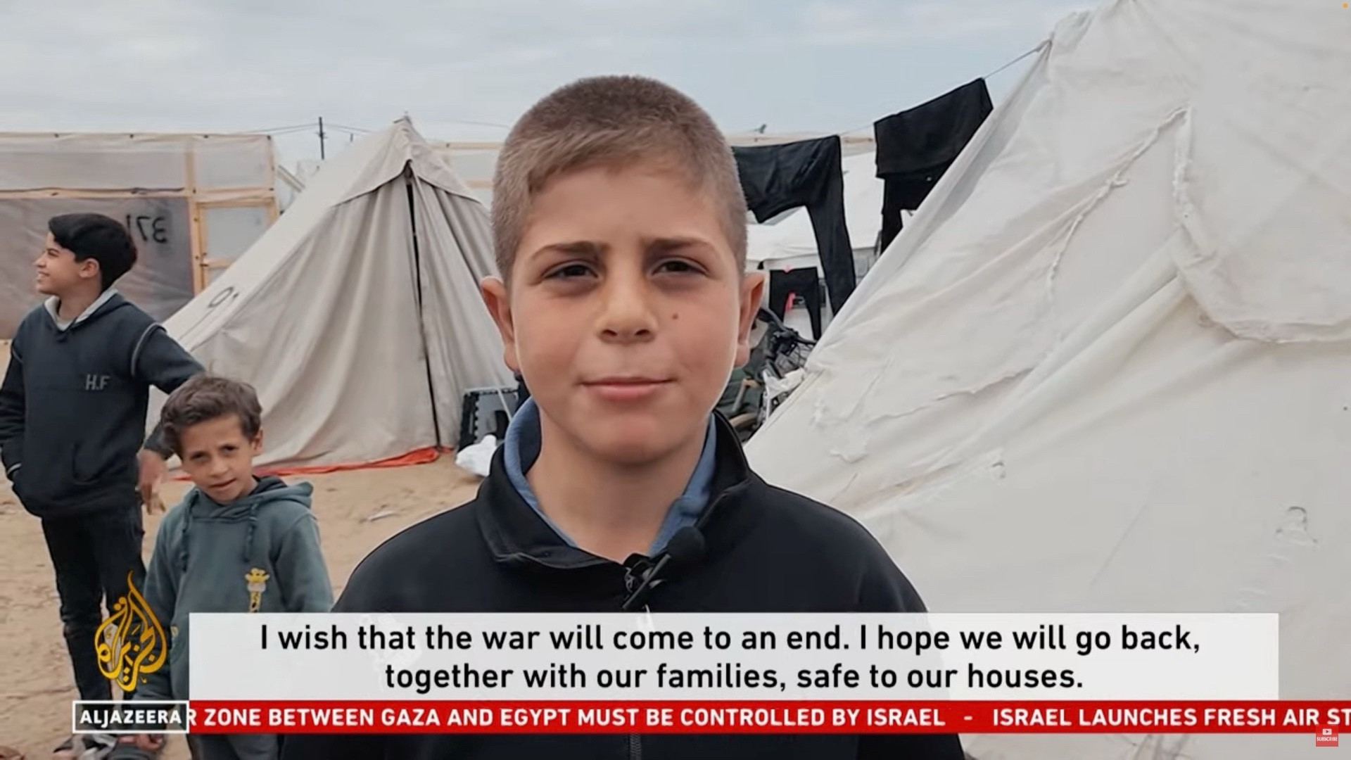 A boy saying “I wish that the war will come to an end. I hope we will go back, together with our families, safe to our houses.”