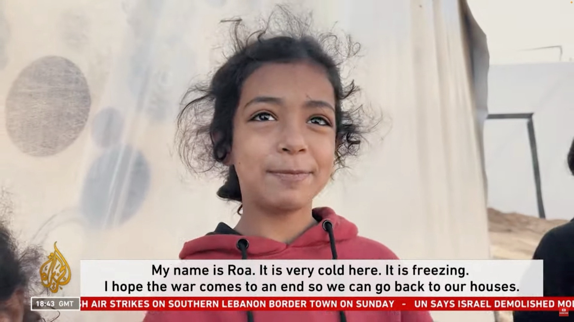 A girl saying: “My name is Roa. It is very cold here. It is freezing. I hope the war comes to an end so we can go back to our houses.”