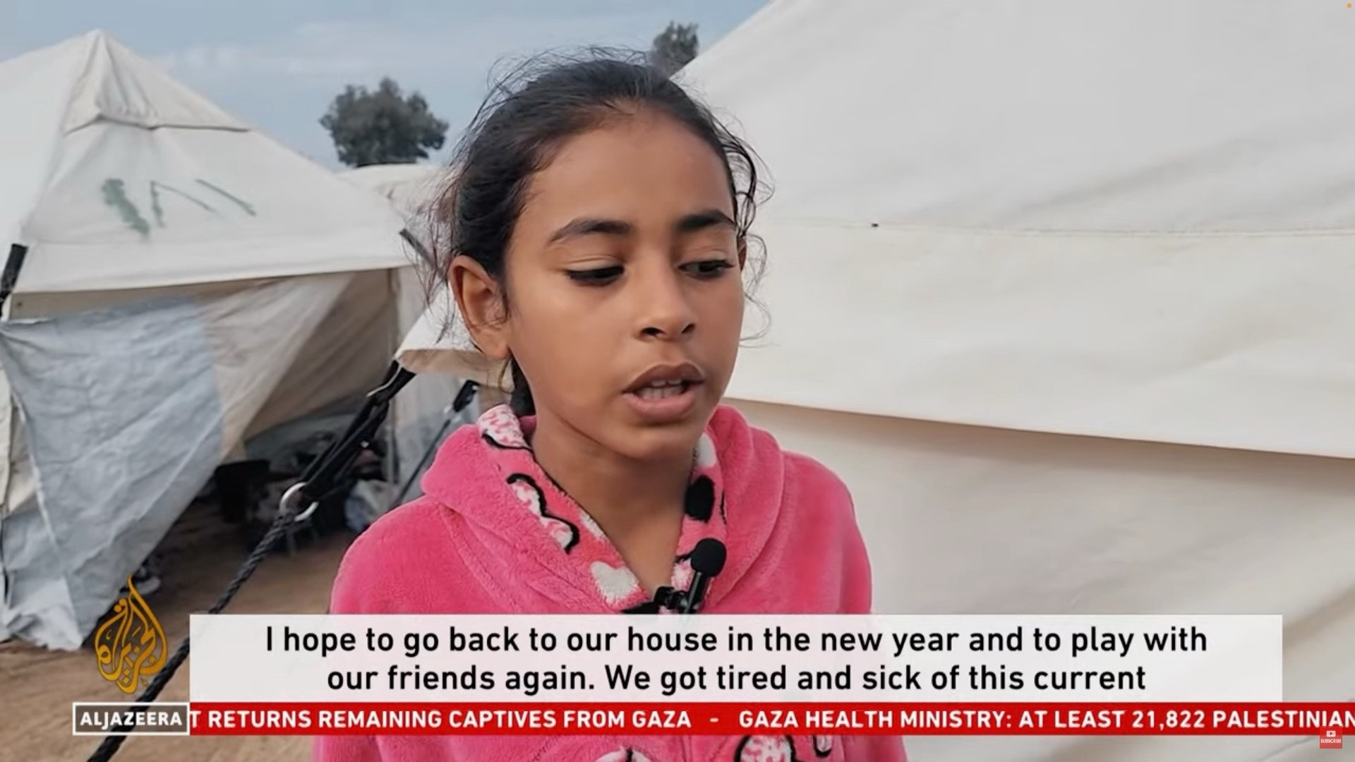 A girl saying: “I hope to go back to our house in the new year and to play with our friends again. We got tired and sick of this current…”