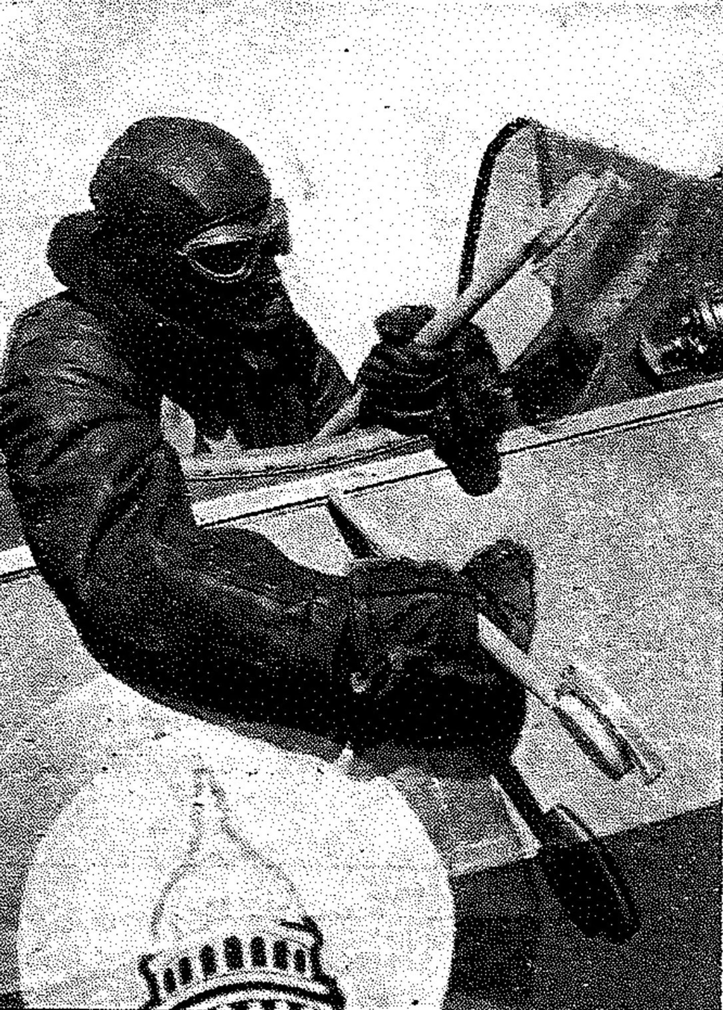 A scientist in 1933 sitting in an open cockpit, ready to catch some spores.