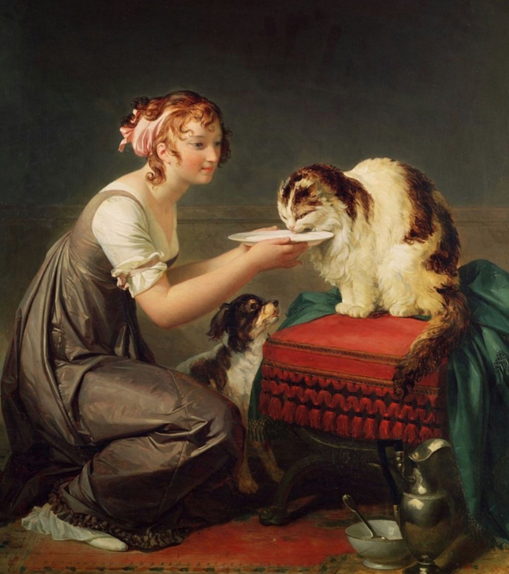 Oil painting of a pretty young white woman kneeling on a carpeted floor, holding a plate of food up for a fluffy tabby and white cat which is devouring whatever is on the plate. The woman has a faint, affectionate smile as she watches the cat eat. There is a small dog sitting up on the floor, looking eagerly at these lunch proceedings but he's apparently not invited.