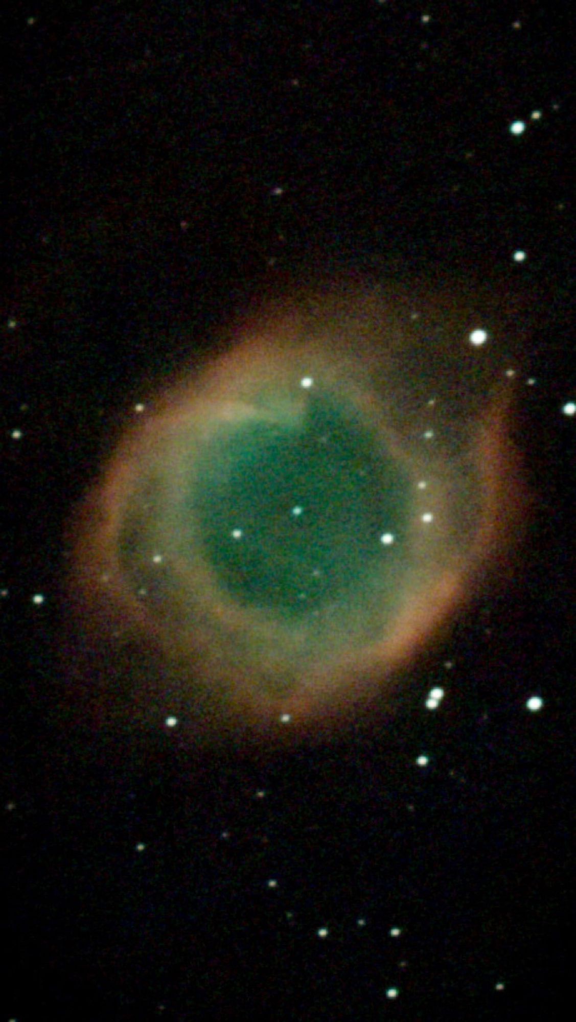 The Helix planetary nebula through an astrophotography telescope 

a type of emission nebula consisting of an expanding, glowing shell of ionized gas ejected from red giant stars late in their lives.