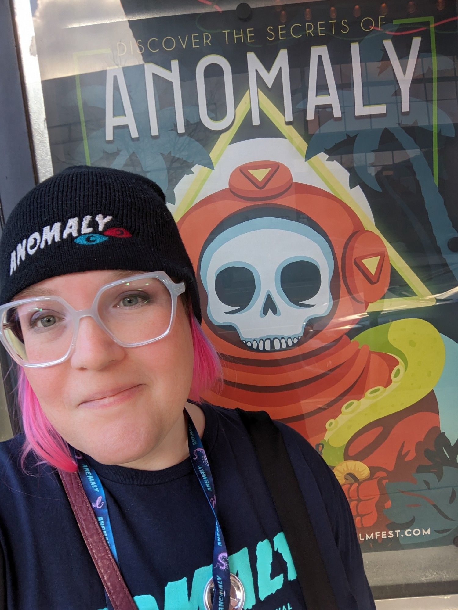 Self-portrait in front of the poster I designed for Anomaly.