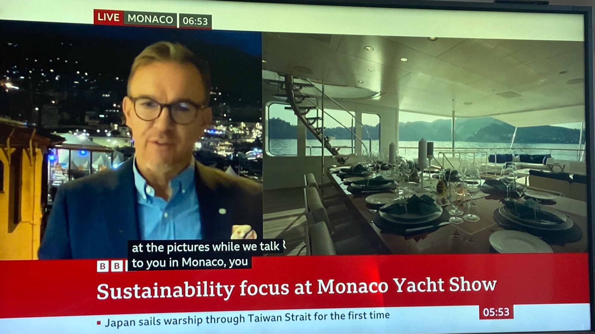 A photo of a TV screen showing the BBC News. The headline reads “sustainability focus at Monaco yacht show.”