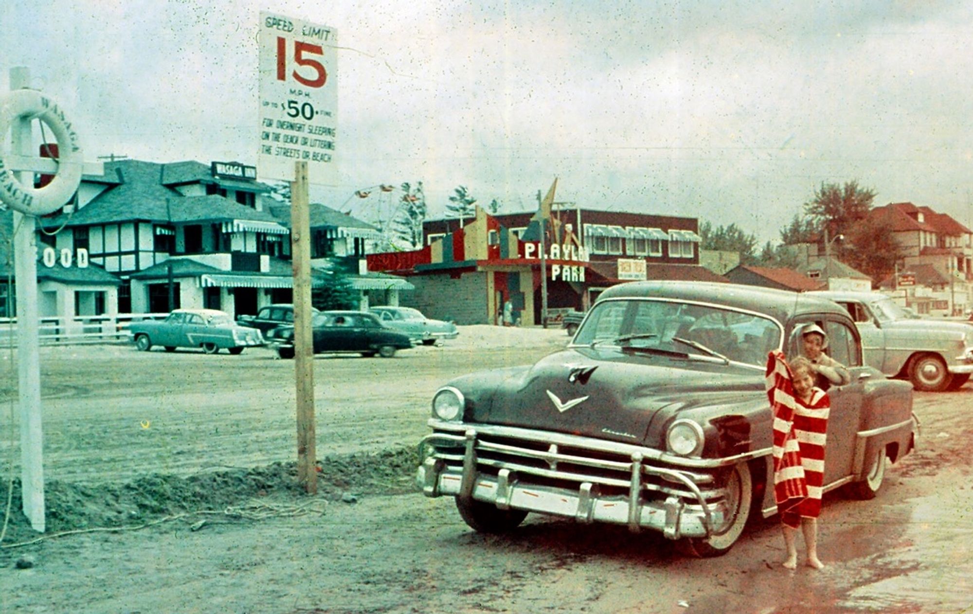 1955 photo from the family stash: My siblings in front of the family car at the beach. (Rye Playland, maybe? They're wet, cleaning up with towels.)