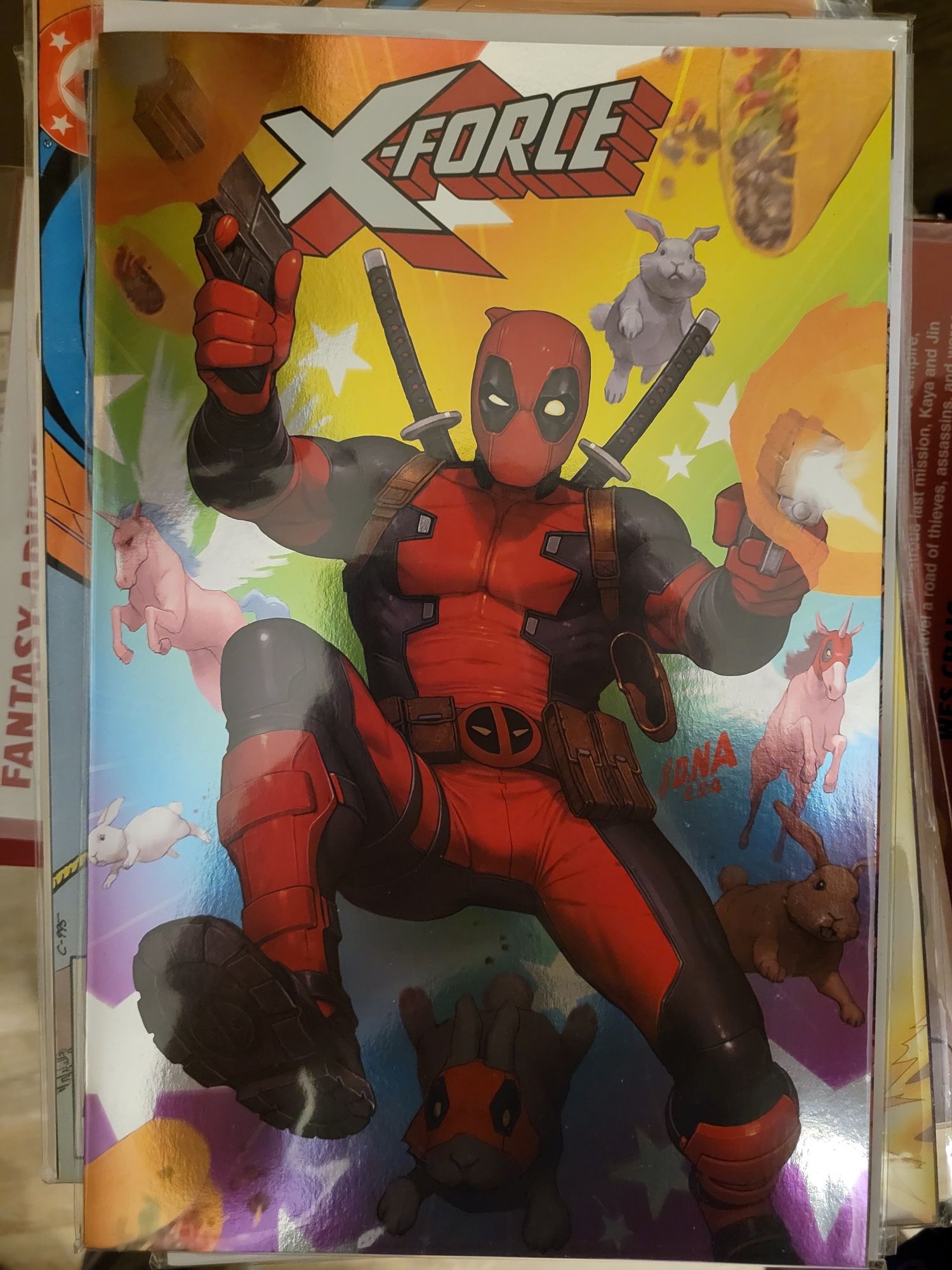 Variant foil cover of X-Force (2024 series) issue #1 by David Nakayama featuring Deadpool, guns blazing, alongside bunnies, unicorns, and tacos (Marvel Comics, 2024)