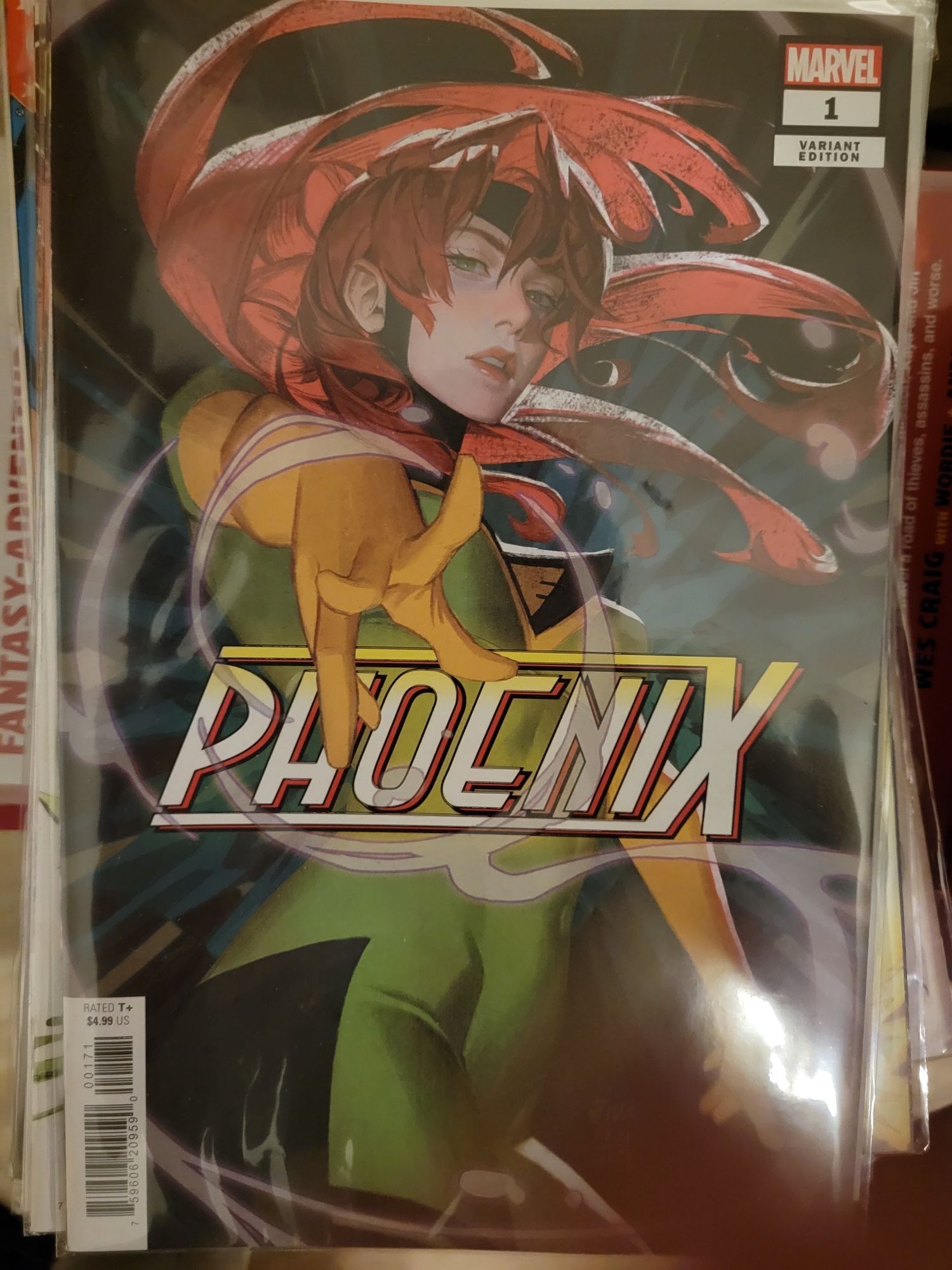 Variant cover of Phoenix issue #1 by Aka, with Jean Grey in her new Phoenix costume reaching out to the reader against a black and dark green burst effect background (Marvel Comics, 2024)