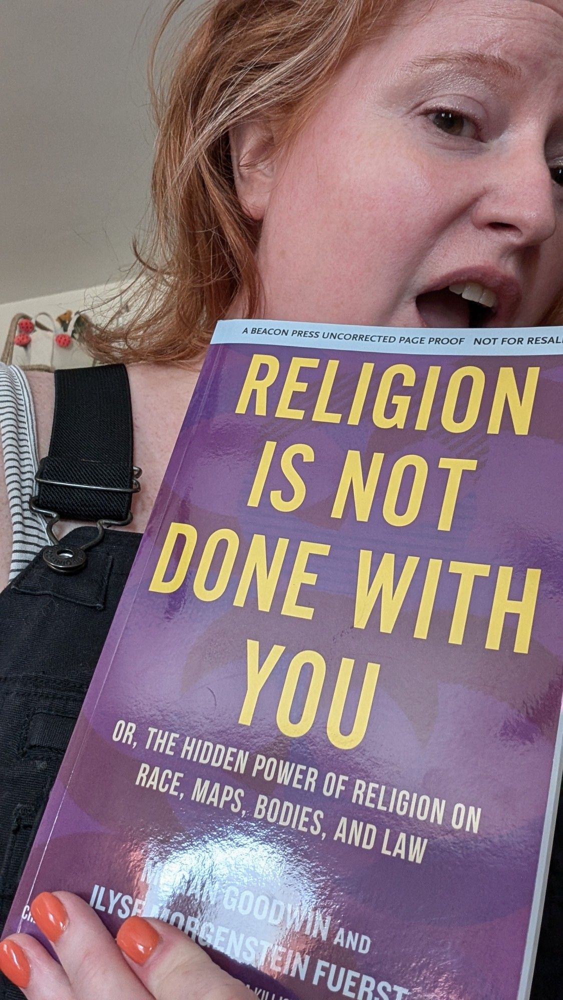 me holding an uncorrected proof of Religion Is Not Done With You