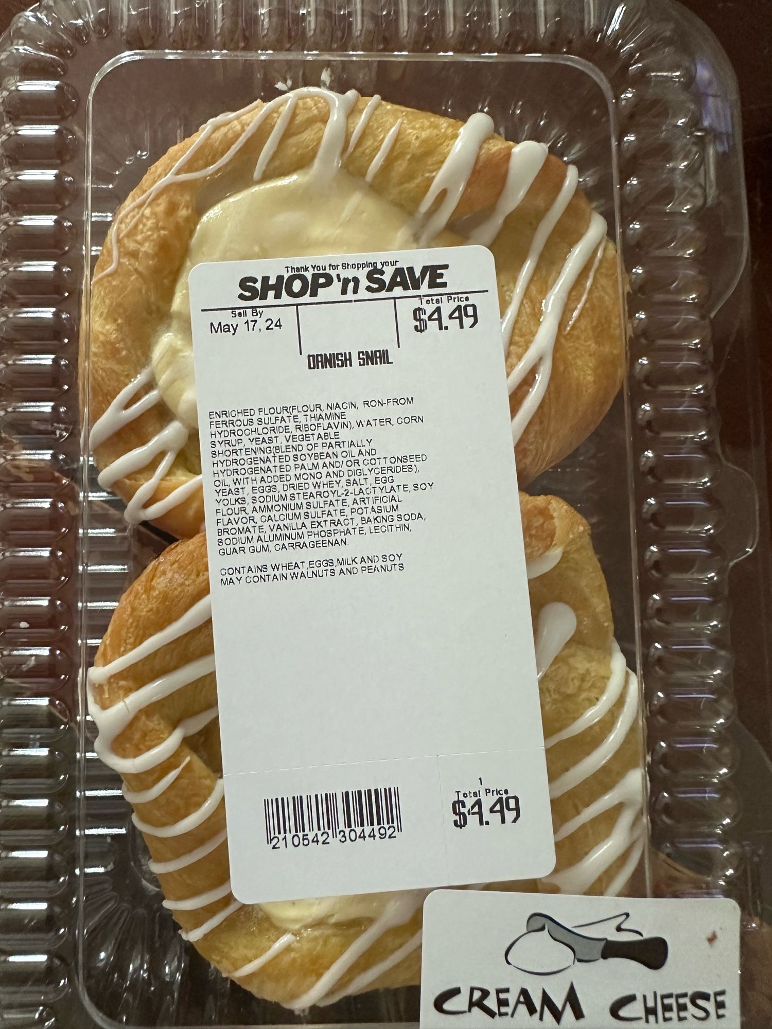 Plastic clamshell package of two cream cheese danish pastries from a supermarket.