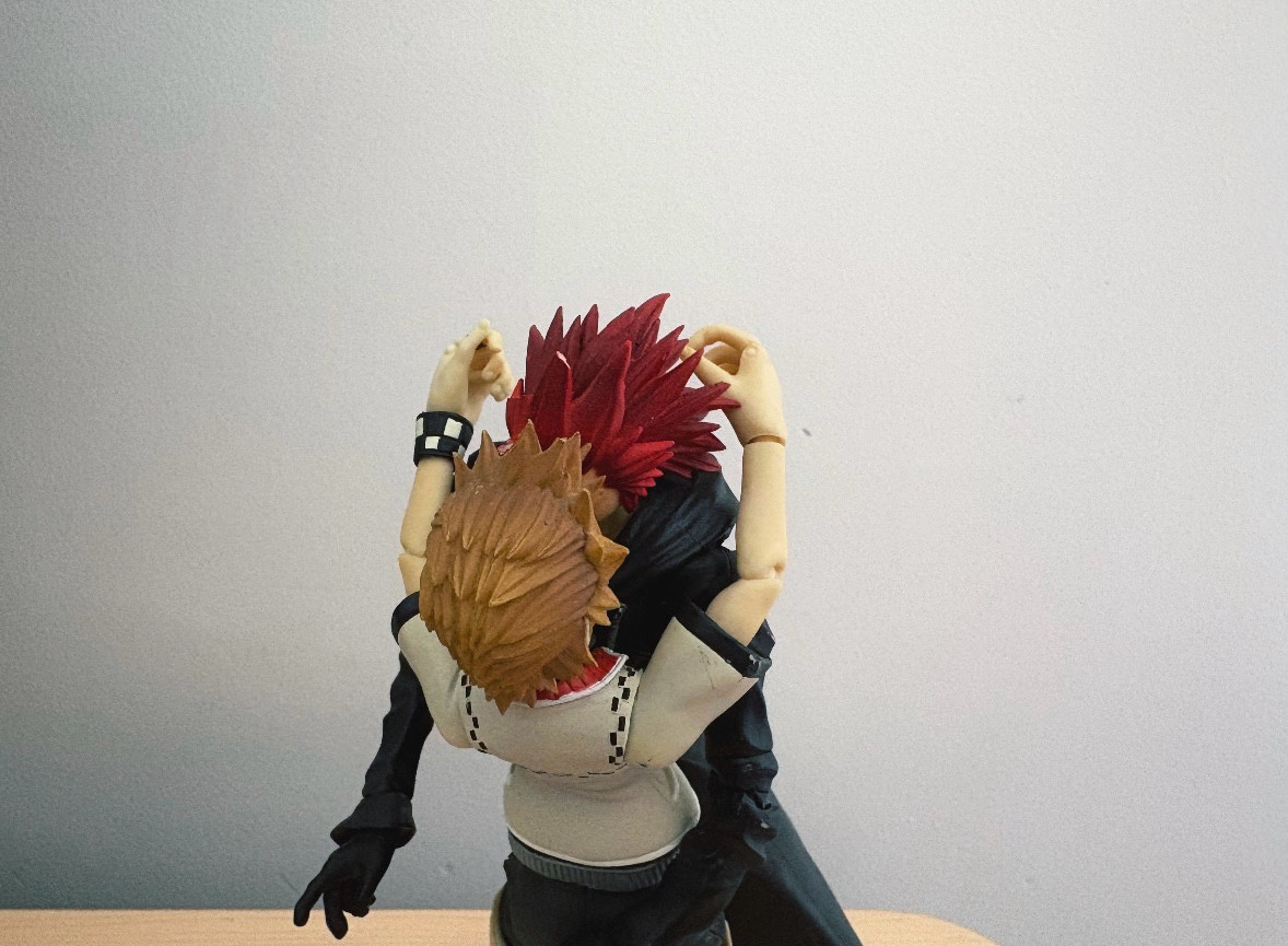 The Axel (right) and Roxas (left) action figures from the Kingdom Hearts II Play Arts series start making out (while still standing upright on the same wooden bench as seen in the first image).