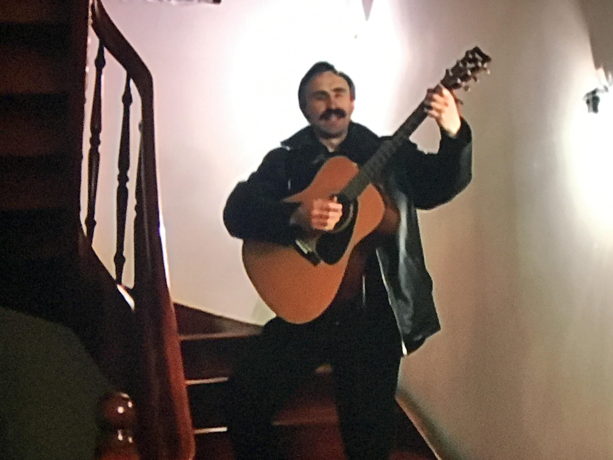igor playing guitar on the stairs in long way round