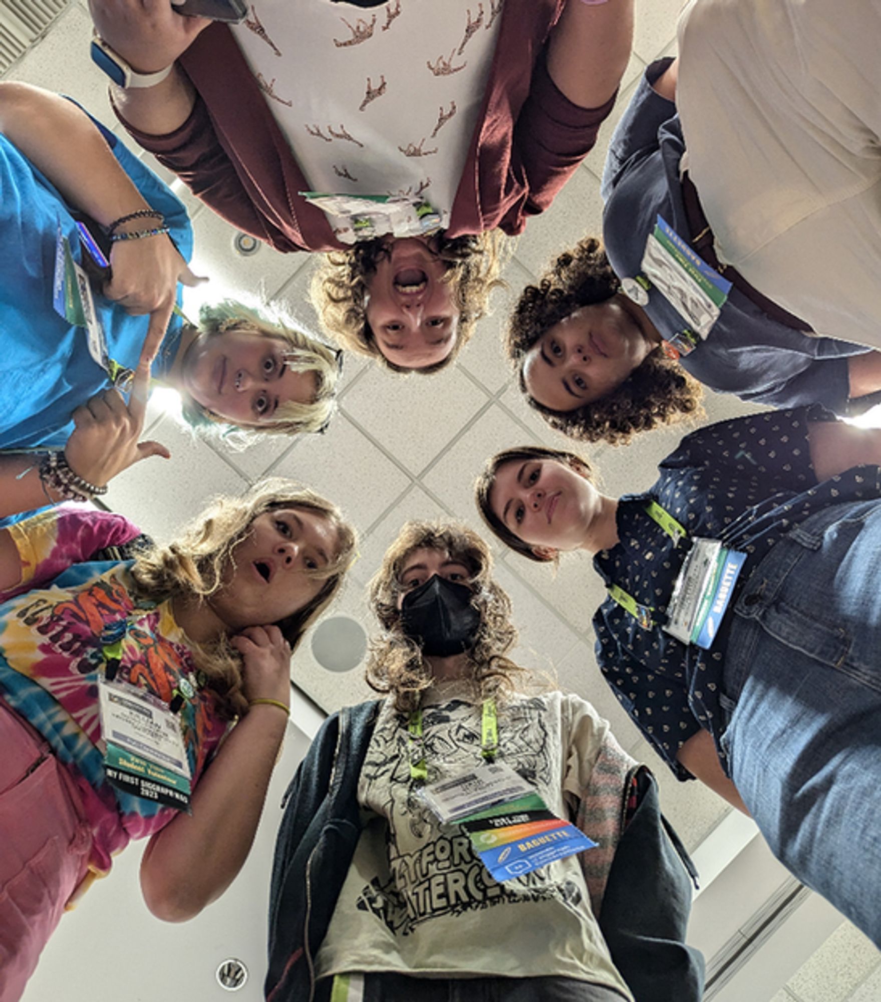 A group photo takrn from the ground. The group is standing in a circle.