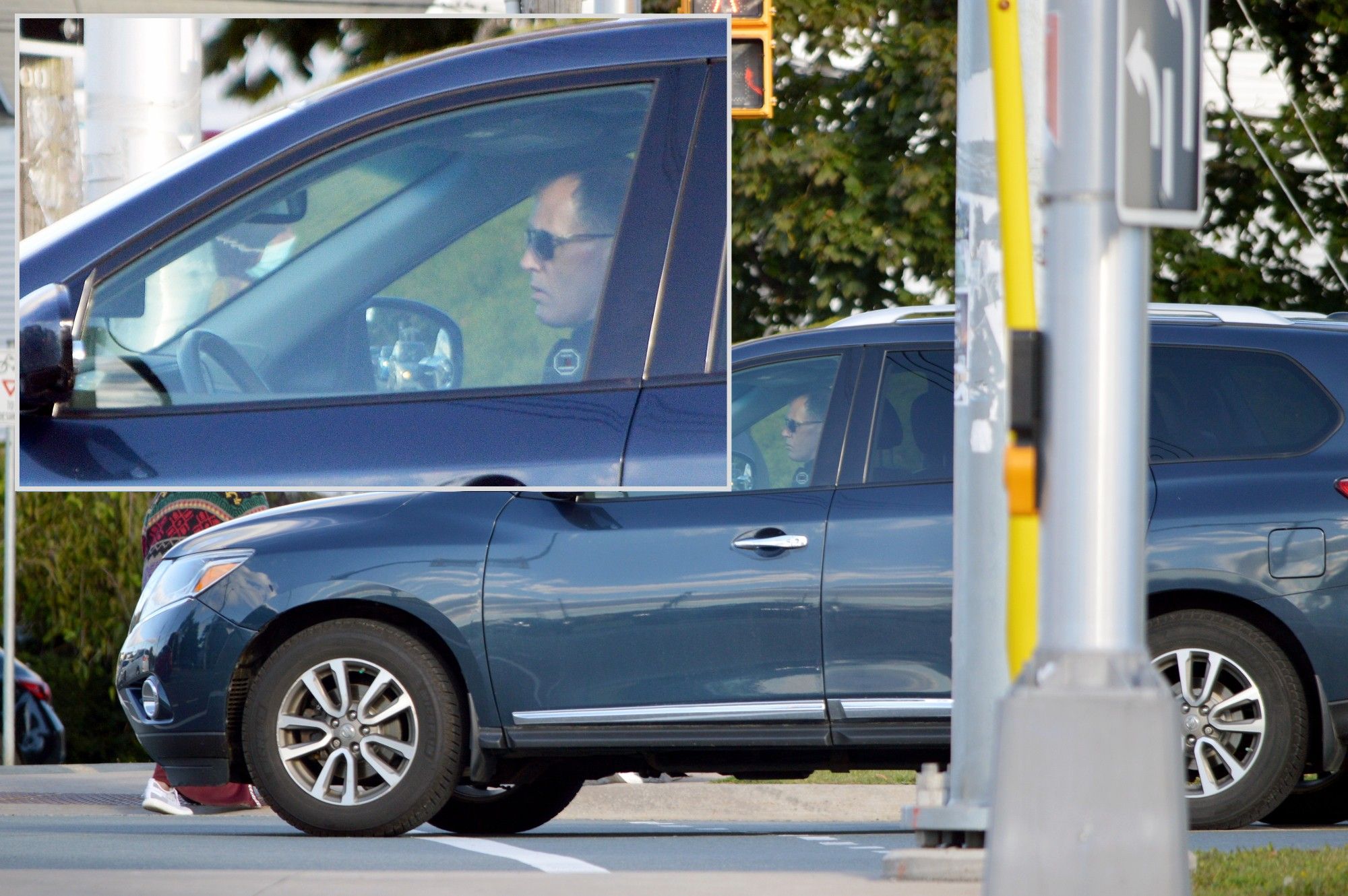 A middle-aged man driving a grey SUV which is stopped in a crosswalk at the corner of East Perimeter Road and Bayers Road.