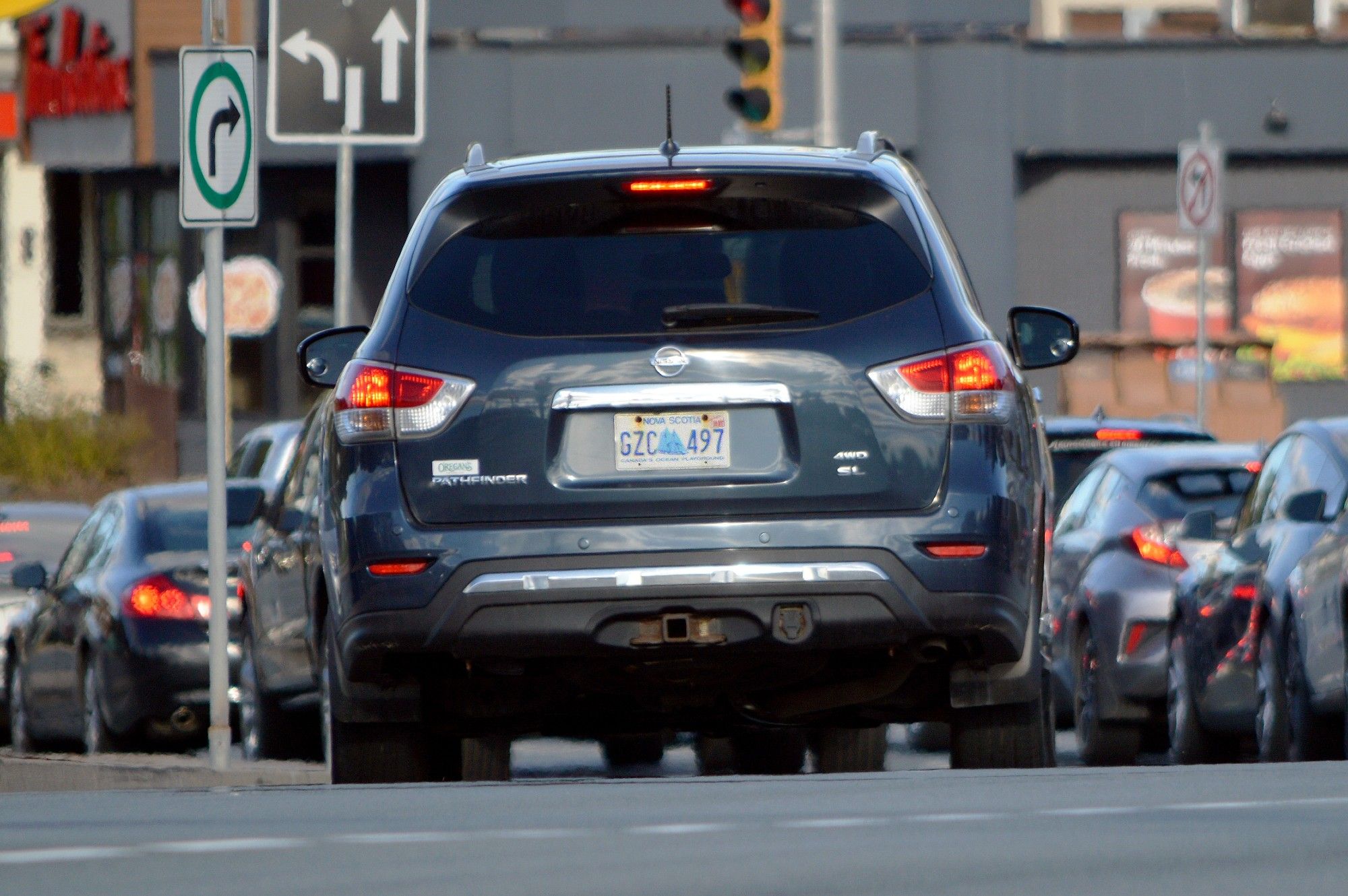 The rear of the same grey SUV, showing the Nova Scotia licence plate: GZC 497.