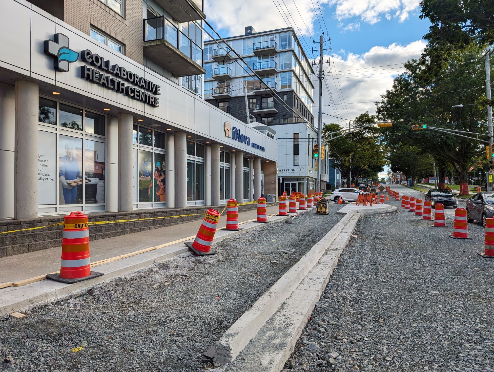 Construction of a bike lane on Almon Street in Halifax, in front of CNIB. Large traffic cones separate the sidewalk from a parallel bike lane under construction.