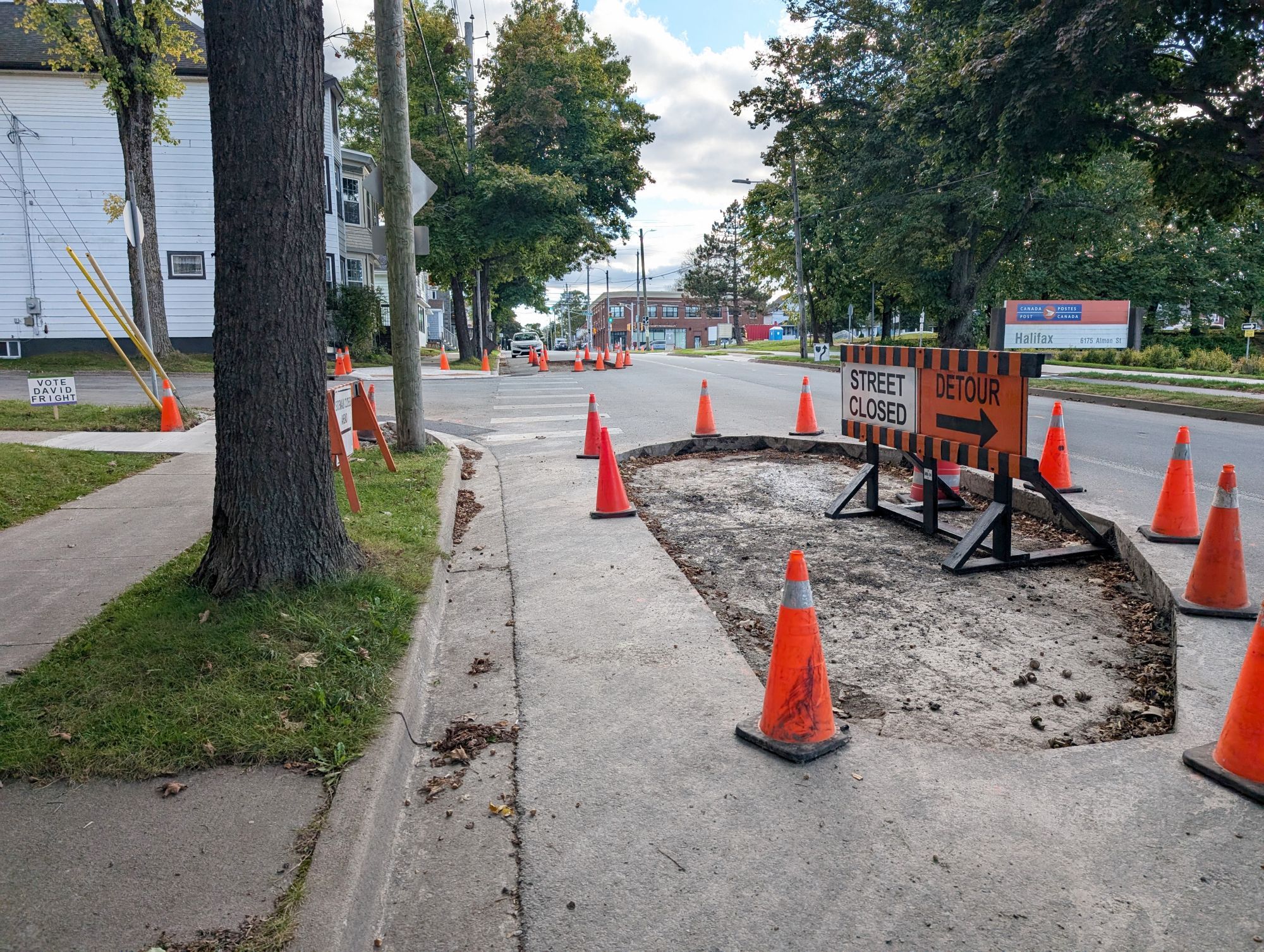 An area of the roadway on Almon Street. Part of the roadway has been dug up and is surrounded by traffic cones.