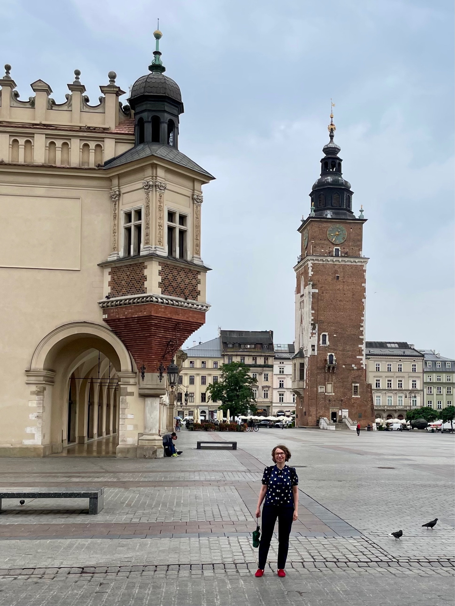 Anna on the central square in Krakow with the clock tower in the background