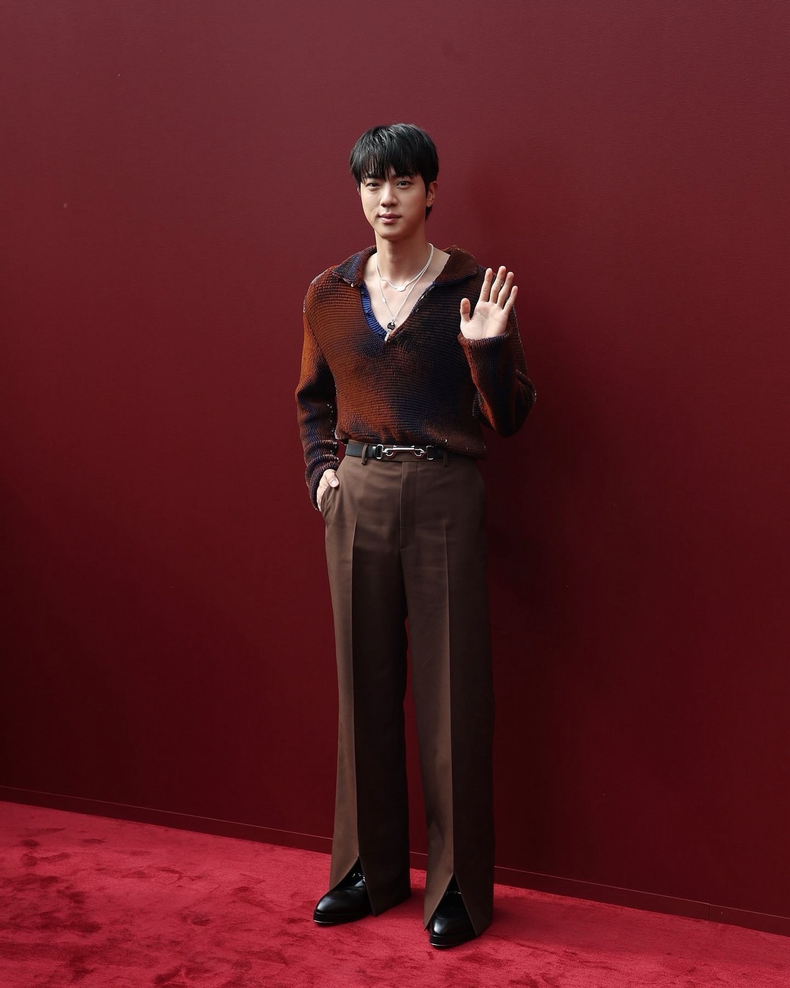 Seokjin wearing a reddish brown outfit at the red carpet of Gucci Summer/Spring 2025 Women’s Fashion Show from MTV’s Instagram.